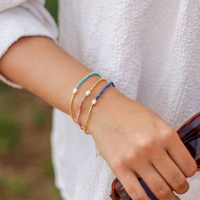trio of white 4mm oval freshwater pearl drawstring bracelets with white and yellow gold coloured beads