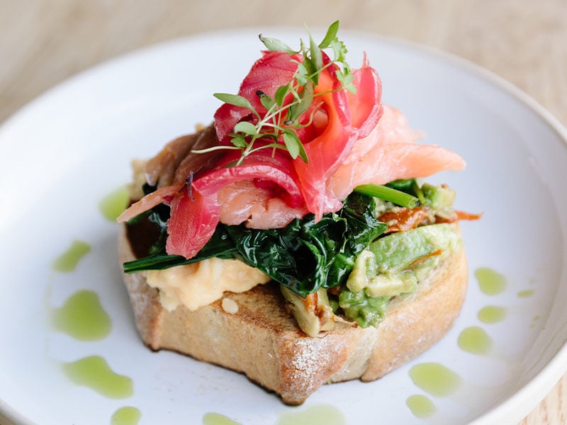 scrambed eggs two ways on toast on a white plate