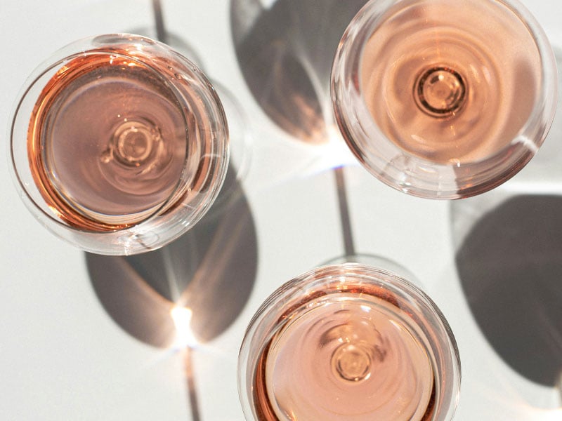 overhead view of three glasses of rose wine