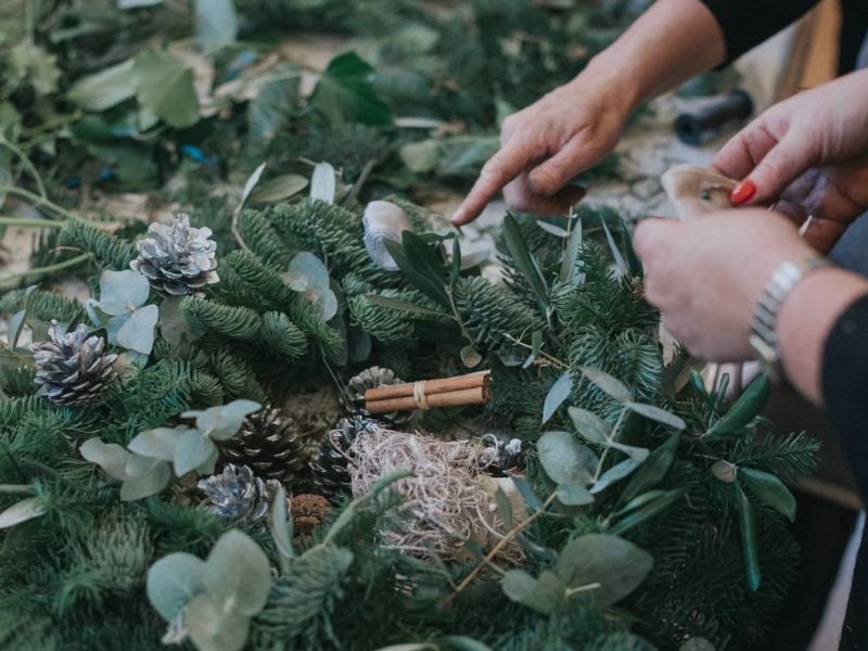 people making a christmas wreath