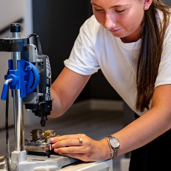 shop assistant drilling a whole to set a pearl at isle of wight pearl