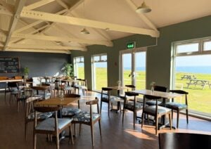 photo of the inside of the pearl cafe with the windows and sea views