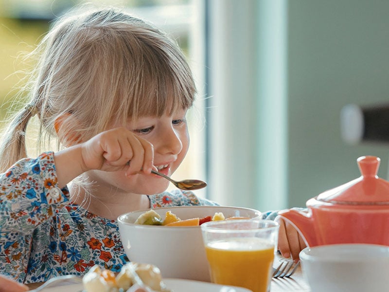 little girl eating breakfast in the pearl cafe