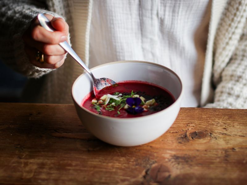 Person eating soup from a bowl in the pearl cafe